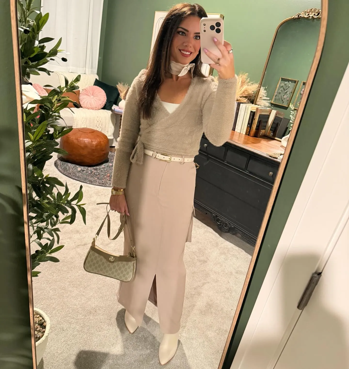 Susanne in a taupe fuzzy wrap sweater and blush cargo maxi skirt with a cream belt, white neck scarf, monogram bag and cream ankle boots