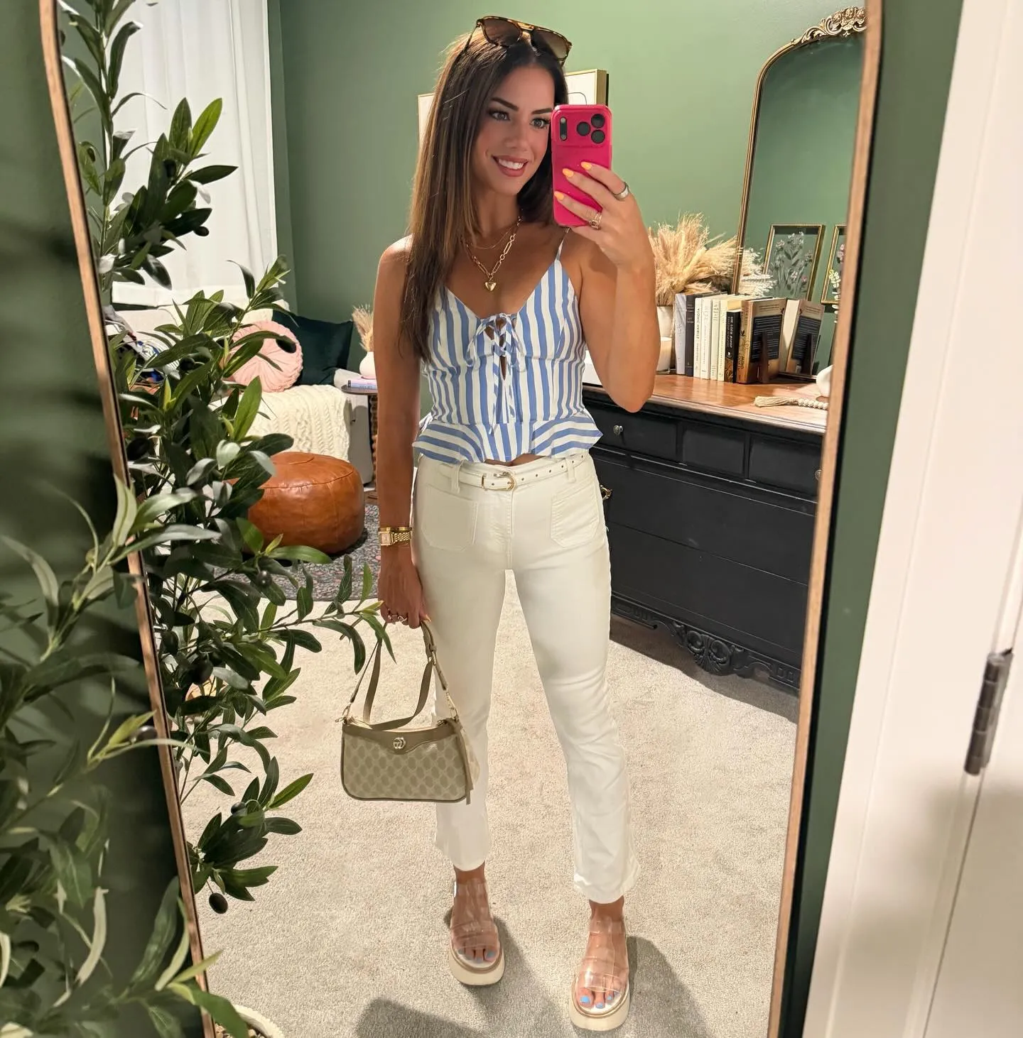 Blue and white striped tie-front peplum tank with cropped white jeans, a white belt, clear platform sandals and a tan monogram shoulder bag.